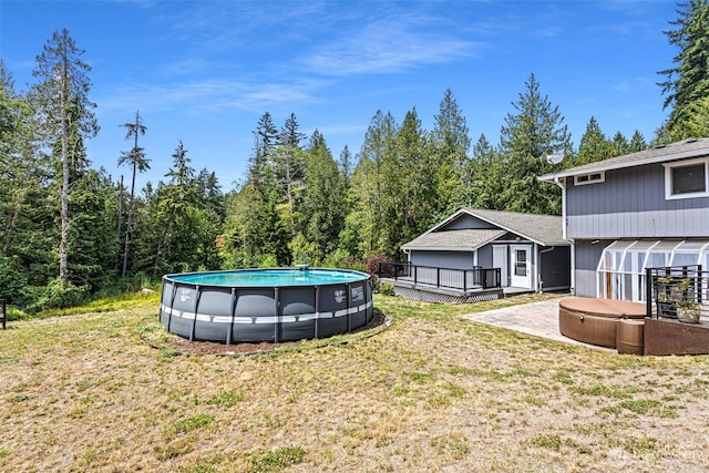 3288 NW Happy Hollow Ln, Silverdale, WA 98383 - view of grassy yard with a hot tub, a wooden deck, and an outdoor pool