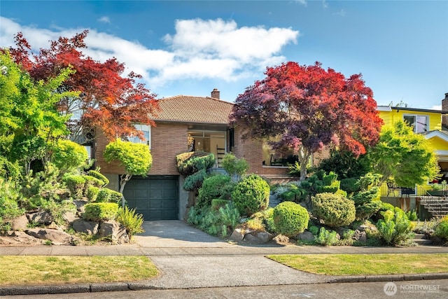2842 NW 67th St, Seattle, WA 98117 - obstructed view of property with a chimney, an attached garage, concrete driveway, and a tile roof