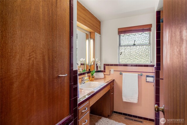 2842 NW 67th St, Seattle, WA 98117 - bathroom with vanity, tile walls, tile patterned flooring, and wainscoting