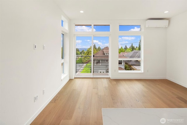 1244 15th Ave E Unit 9, Seattle, WA 98112 - empty room with a wall unit AC, light wood finished floors, and recessed lighting