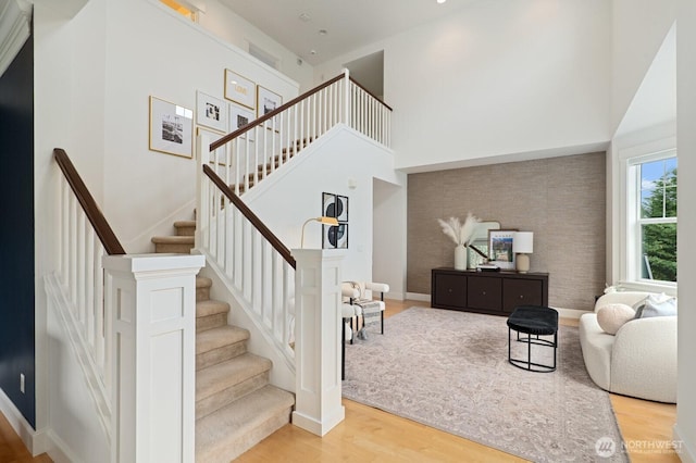 8829 138th Ct SE, Newcastle, WA 98059 - staircase featuring wood finished floors and a high ceiling