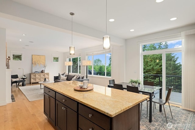 8829 138th Ct SE, Newcastle, WA 98059 - kitchen featuring healthy amount of natural light, light wood-style floors, dark brown cabinets, decorative light fixtures, and recessed lighting