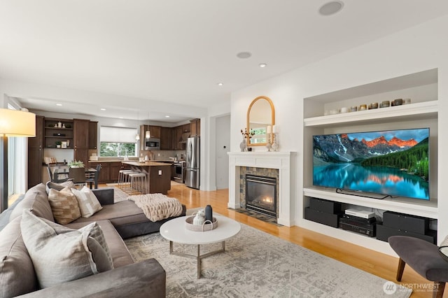 8829 138th Ct SE, Newcastle, WA 98059 - living room with light wood-type flooring, a tile fireplace, and recessed lighting