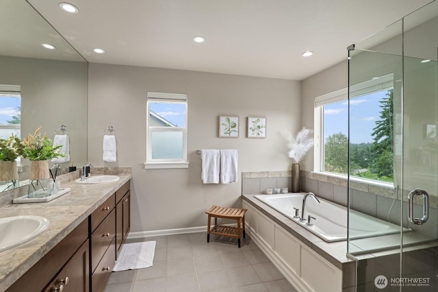 8829 138th Ct SE, Newcastle, WA 98059 - full bath with healthy amount of natural light, double vanity, a bath, recessed lighting, and tile patterned flooring