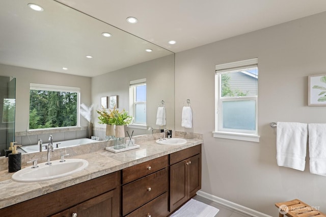 8829 138th Ct SE, Newcastle, WA 98059 - full bathroom featuring plenty of natural light, a bath, double vanity, and recessed lighting