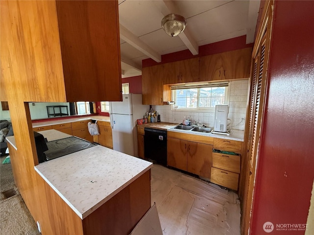1309 29th St, Anacortes, WA 98221 - kitchen featuring black dishwasher, freestanding refrigerator, light countertops, and decorative backsplash