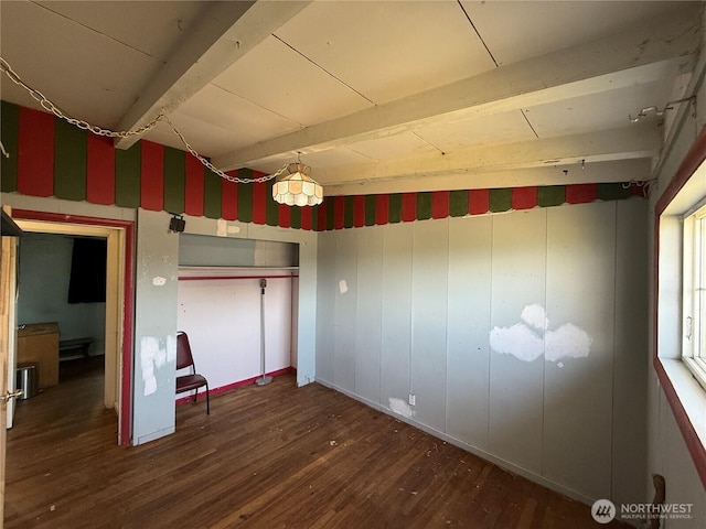 1309 29th St, Anacortes, WA 98221 - unfurnished bedroom with wood finished floors, beamed ceiling, and a closet