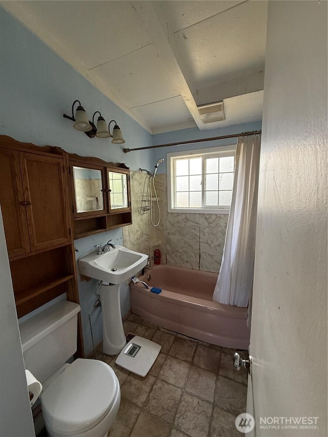 1309 29th St, Anacortes, WA 98221 - bathroom featuring shower / tub combo with curtain and stone tile flooring