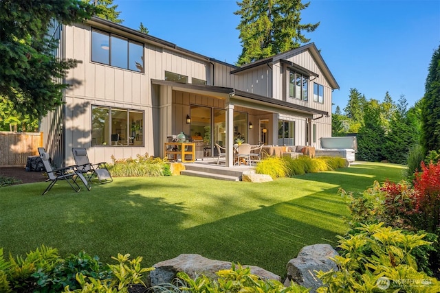 4405 88th Ave SE, Mercer Island, WA 98040 - back of house with board and batten siding, an outdoor living space, and a patio