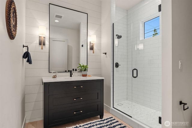 4405 88th Ave SE, Mercer Island, WA 98040 - bathroom featuring a stall shower, vanity, and wood finished floors