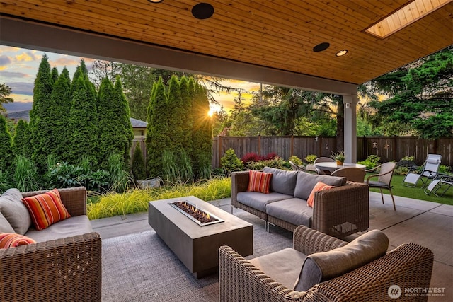 4405 88th Ave SE, Mercer Island, WA 98040 - patio terrace at dusk with an outdoor living space with a fire pit, a patio area, a fenced backyard, and outdoor dining area