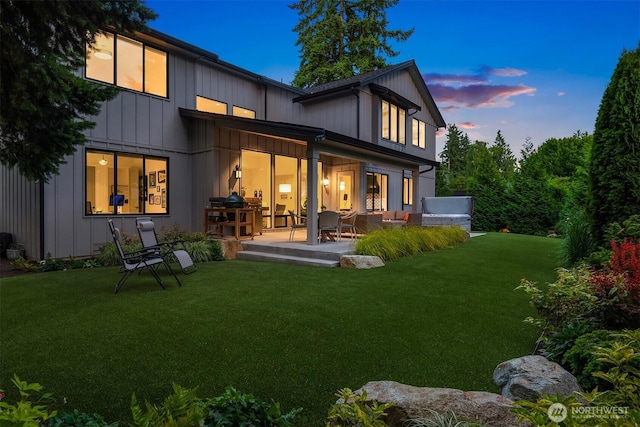 4405 88th Ave SE, Mercer Island, WA 98040 - back of house at dusk with a patio, a yard, and an outdoor living space