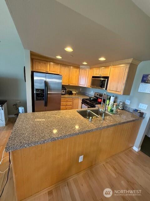 2103 Tacoma Ct, Tacoma, WA 98405 - kitchen featuring stainless steel appliances, light wood-type flooring, a peninsula, dark stone countertops, and recessed lighting