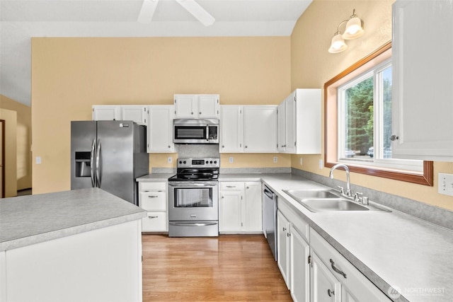 7609 39th Ct SE, Lacey, WA 98503 - kitchen with appliances with stainless steel finishes, white cabinetry, light wood-style flooring, light countertops, and a ceiling fan