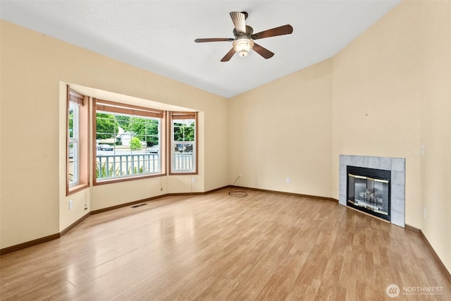 7609 39th Ct SE, Lacey, WA 98503 - unfurnished living room featuring light wood-style floors, a tile fireplace, and a ceiling fan
