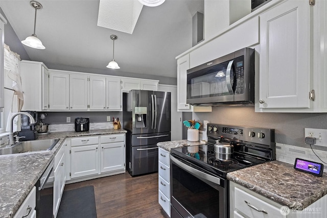 2253 Wellman Pl, Oak Harbor, WA 98277 - kitchen with appliances with stainless steel finishes, a skylight, white cabinets, dark wood-style floors, and pendant lighting