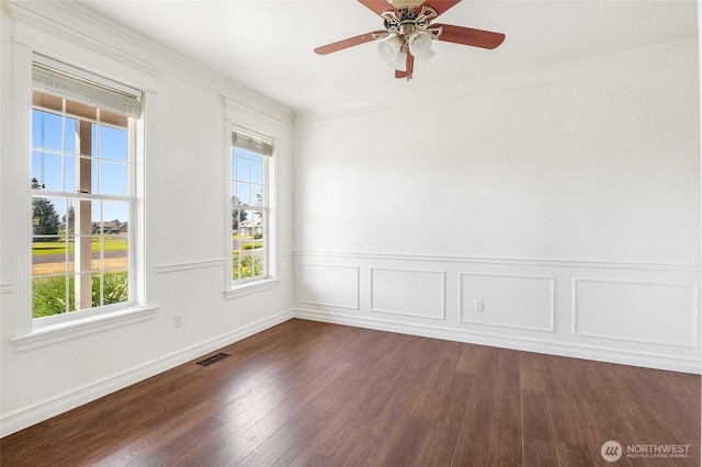 5476 Lorri Ln, Moses Lake, WA 98837 - empty room with dark wood-style flooring, crown molding, ceiling fan, and a wainscoted wall