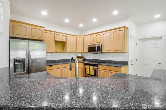 5476 Lorri Ln, Moses Lake, WA 98837 - kitchen with stainless steel appliances, decorative backsplash, light brown cabinetry, recessed lighting, and dark stone countertops