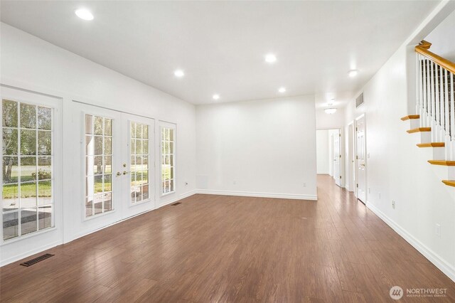 5476 Lorri Ln, Moses Lake, WA 98837 - empty room featuring stairway, wood finished floors, healthy amount of natural light, recessed lighting, and french doors