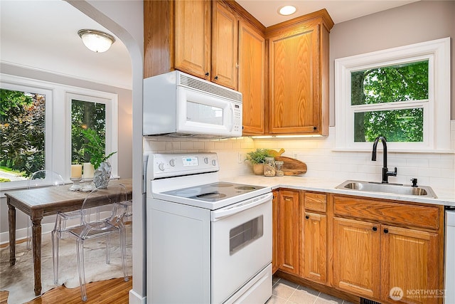8047 Earl Ave NW, Seattle, WA 98117 - kitchen featuring white appliances, decorative backsplash, light countertops, and brown cabinets