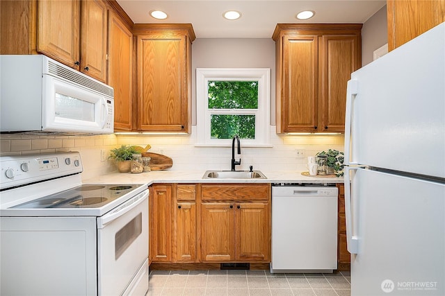 8047 Earl Ave NW, Seattle, WA 98117 - kitchen with white appliances, light countertops, decorative backsplash, recessed lighting, and brown cabinets