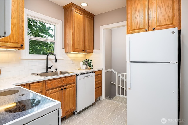 8047 Earl Ave NW, Seattle, WA 98117 - kitchen with white appliances, tasteful backsplash, light tile patterned floors, brown cabinets, and recessed lighting