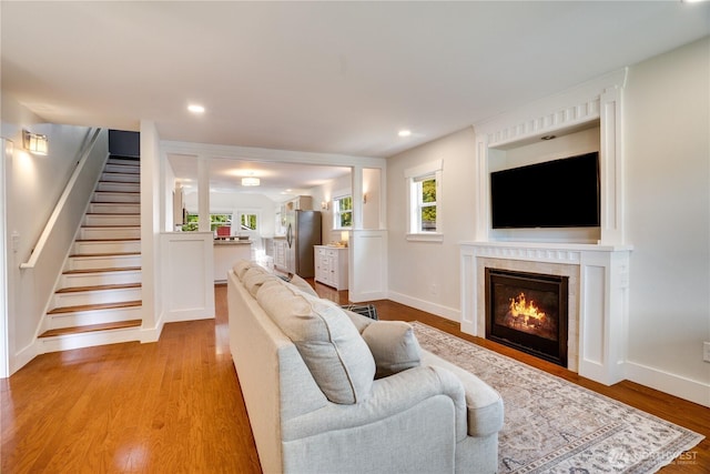 5111 N 39th St, Tacoma, WA 98407 - living room with healthy amount of natural light, stairway, a glass covered fireplace, light wood-style floors, and recessed lighting
