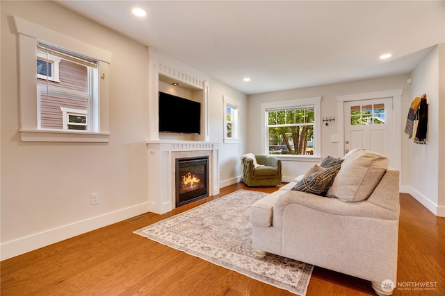 5111 N 39th St, Tacoma, WA 98407 - living room featuring wood finished floors, a glass covered fireplace, and recessed lighting
