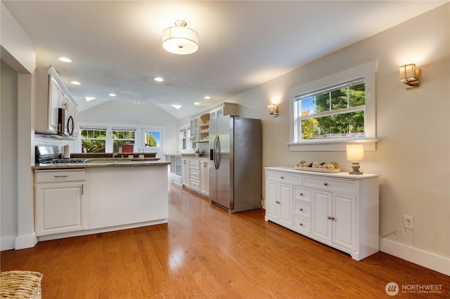 5111 N 39th St, Tacoma, WA 98407 - kitchen featuring stainless steel appliances, white cabinets, light wood-style flooring, plenty of natural light, and lofted ceiling