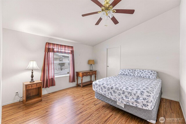 6350 Portal Way Unit 75, Ferndale, WA 98248 - bedroom featuring vaulted ceiling, wood finished floors, and ceiling fan