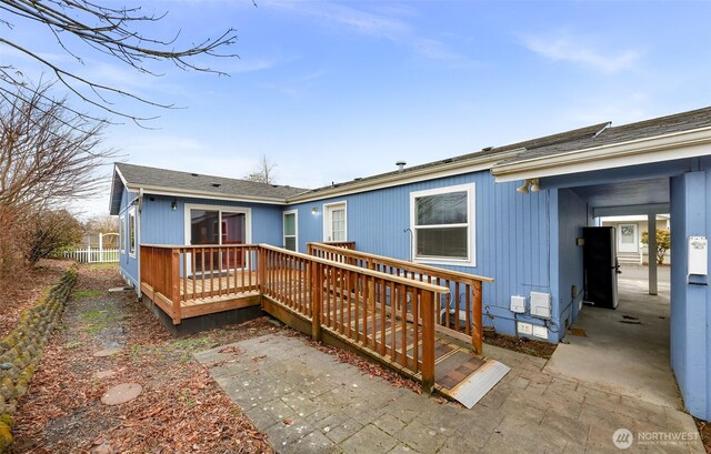 6350 Portal Way Unit 75, Ferndale, WA 98248 - back of house featuring a deck, roof with shingles, and a patio
