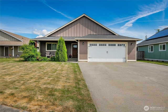 406 Harrison Ln, Nooksack, WA 98276 - view of front facade with board and batten siding, a front yard, an attached garage, asphalt driveway, and covered porch