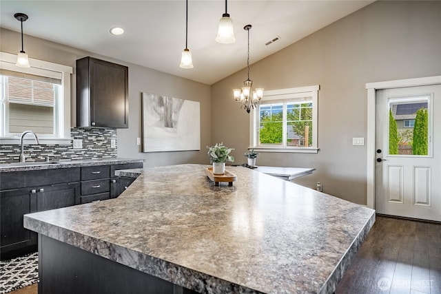 406 Harrison Ln, Nooksack, WA 98276 - kitchen with vaulted ceiling, dark wood-type flooring, backsplash, a kitchen island, and recessed lighting