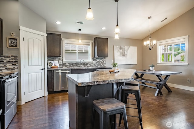 406 Harrison Ln, Nooksack, WA 98276 - kitchen featuring stainless steel appliances, dark brown cabinetry, backsplash, dark wood finished floors, and lofted ceiling