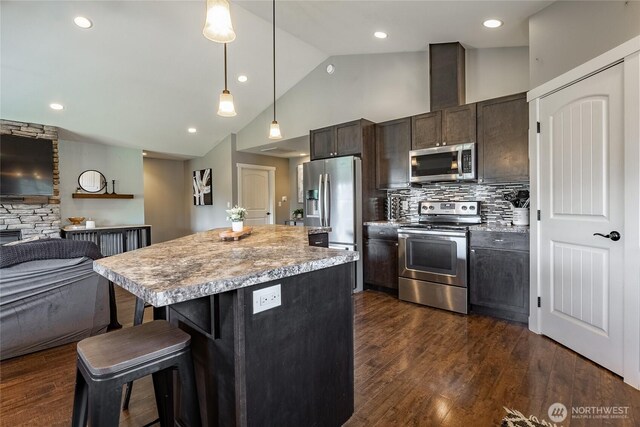406 Harrison Ln, Nooksack, WA 98276 - kitchen with appliances with stainless steel finishes, a breakfast bar area, a kitchen island, hanging light fixtures, and open floor plan