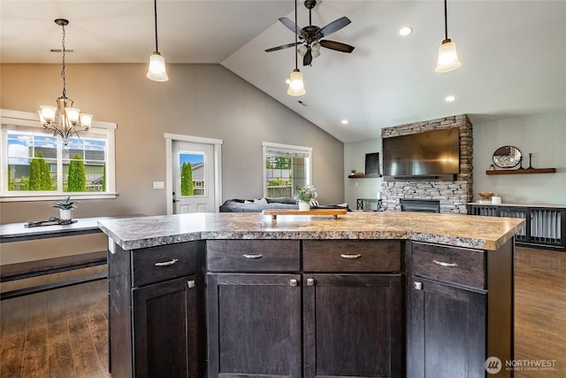 406 Harrison Ln, Nooksack, WA 98276 - kitchen with open floor plan, a ceiling fan, dark wood-style flooring, a stone fireplace, and light countertops