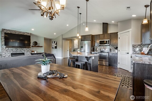 406 Harrison Ln, Nooksack, WA 98276 - dining area with dark wood-style flooring, high vaulted ceiling, a fireplace, a chandelier, and recessed lighting