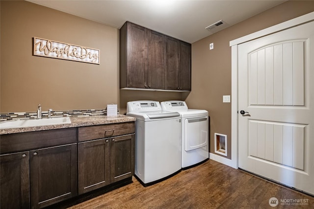 406 Harrison Ln, Nooksack, WA 98276 - laundry area with cabinet space, washer and dryer, and dark wood-type flooring