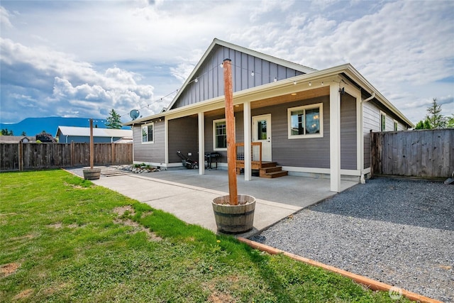 406 Harrison Ln, Nooksack, WA 98276 - rear view of property featuring board and batten siding, a fenced backyard, a patio area, and a mountain view