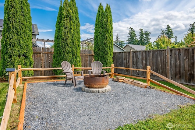 406 Harrison Ln, Nooksack, WA 98276 - fenced backyard with an outdoor fire pit and a patio area