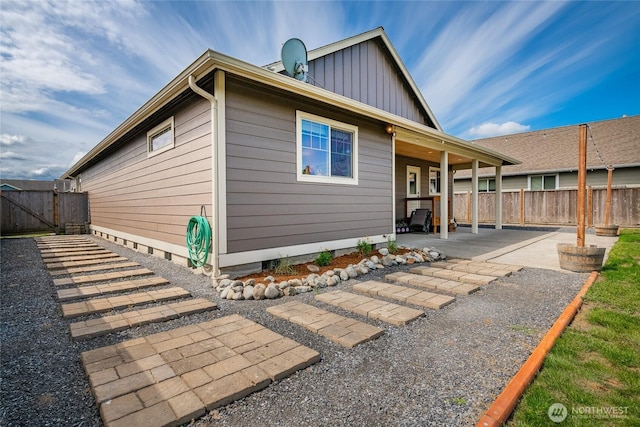 406 Harrison Ln, Nooksack, WA 98276 - back of property featuring board and batten siding, a patio, and a gate