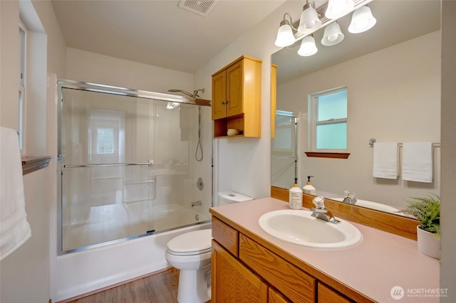 632 97th Ave SE, Lake Stevens, WA 98258 - bathroom featuring vanity, a chandelier, shower / bath combination with glass door, and wood finished floors