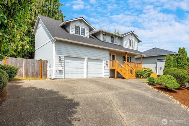 632 97th Ave SE, Lake Stevens, WA 98258 - traditional-style home with concrete driveway, covered porch, a garage, stairway, and a shingled roof