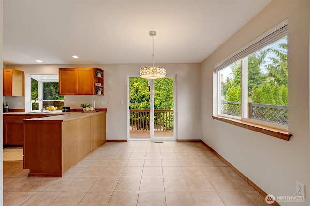 632 97th Ave SE, Lake Stevens, WA 98258 - kitchen featuring a peninsula, healthy amount of natural light, pendant lighting, light countertops, and recessed lighting