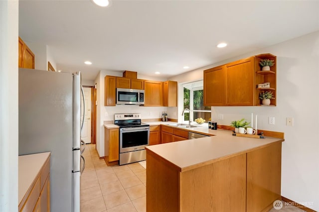 632 97th Ave SE, Lake Stevens, WA 98258 - kitchen featuring appliances with stainless steel finishes, a peninsula, light countertops, light tile patterned floors, and open shelves