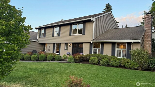 4546 193rd Pl SE, Issaquah, WA 98027 - colonial home with a chimney, a front yard, roof with shingles, and brick siding