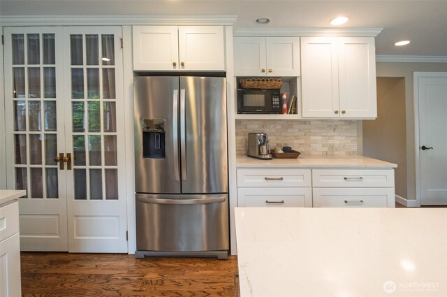 4546 193rd Pl SE, Issaquah, WA 98027 - kitchen with stainless steel fridge with ice dispenser, black microwave, backsplash, white cabinets, and dark wood-type flooring