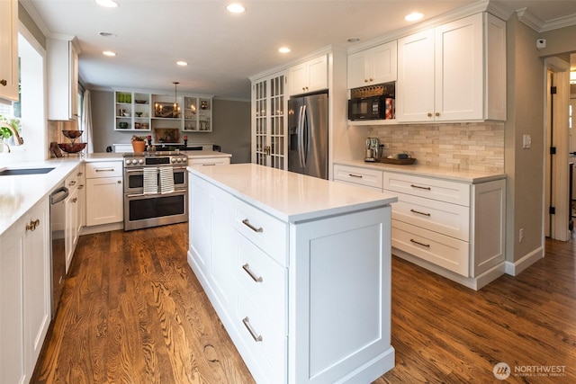 4546 193rd Pl SE, Issaquah, WA 98027 - kitchen featuring appliances with stainless steel finishes, ornamental molding, a center island, recessed lighting, and dark wood-style flooring