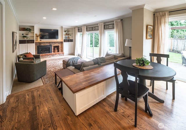 4546 193rd Pl SE, Issaquah, WA 98027 - living area with ornamental molding, a brick fireplace, dark wood-type flooring, built in features, and recessed lighting