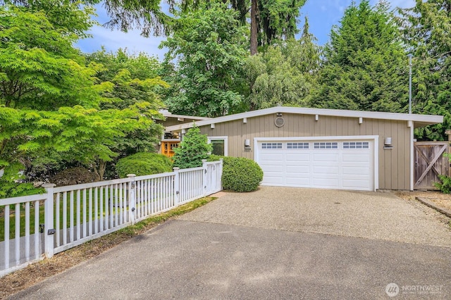 11446 Ohde Ave, Kirkland, WA 98033 - view of front facade with driveway, a garage, and an outbuilding